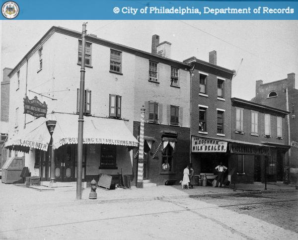 Northeast Corner - 13th and Wood Streets. Henry Martin's Building Establishment and Various Store Fronts.